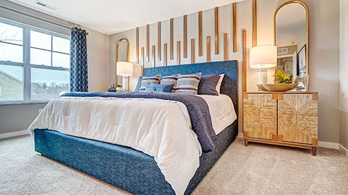 furnished primary bedroom with double window