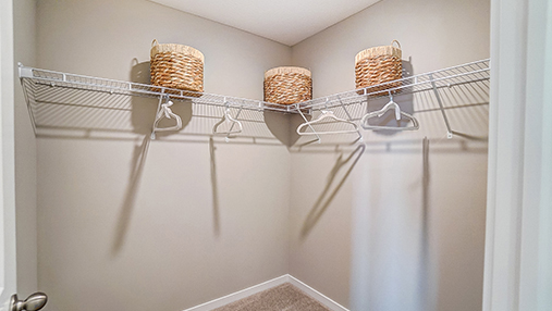 primary walk in closet with wire shelving