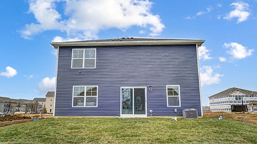 two story home with blue siding rear exterior
