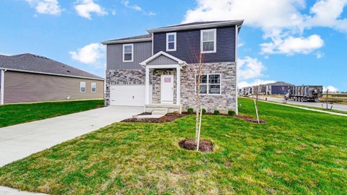 two story home with grey siding, partial stone front, covered entry, two car garage - Fairton floor plan