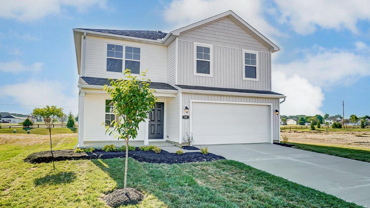 two story home with white siding, covered entry and two car garage