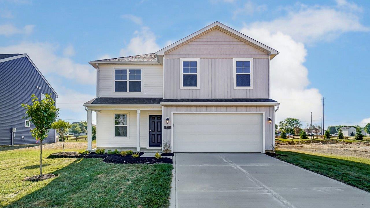 two story home with white siding, covered entry and two car garage