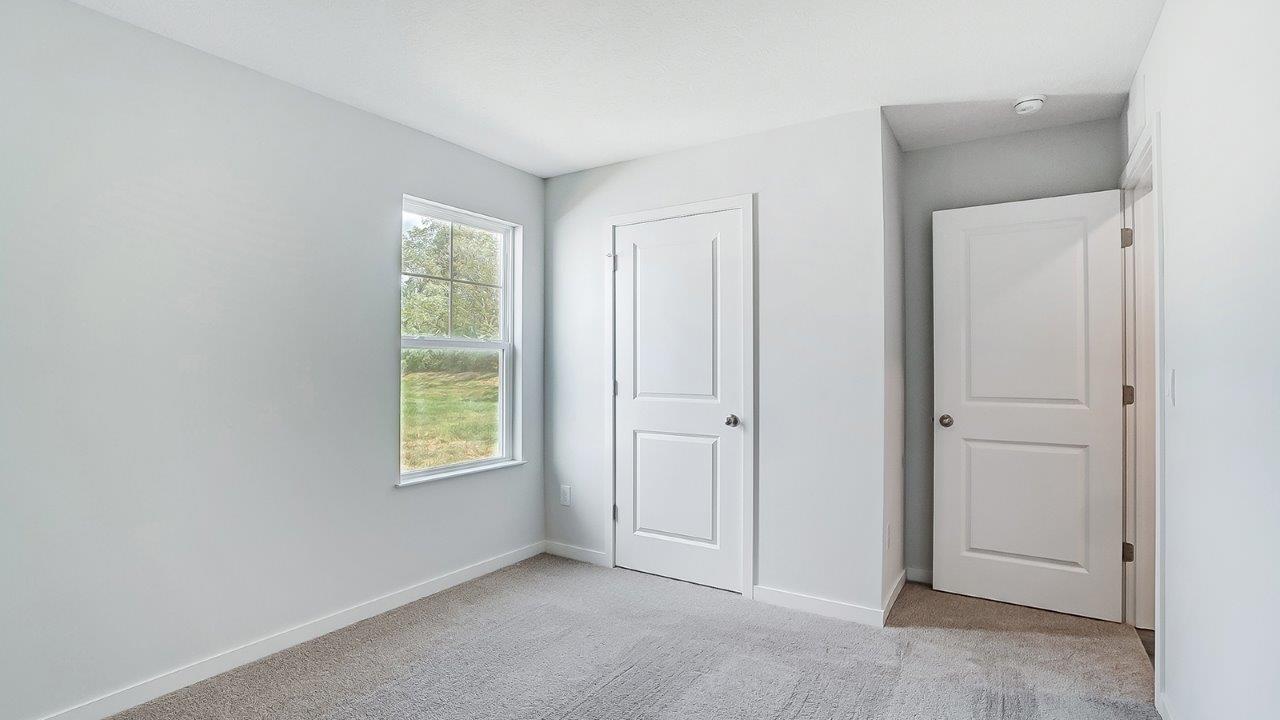 second bedroom with single window, closet and entry