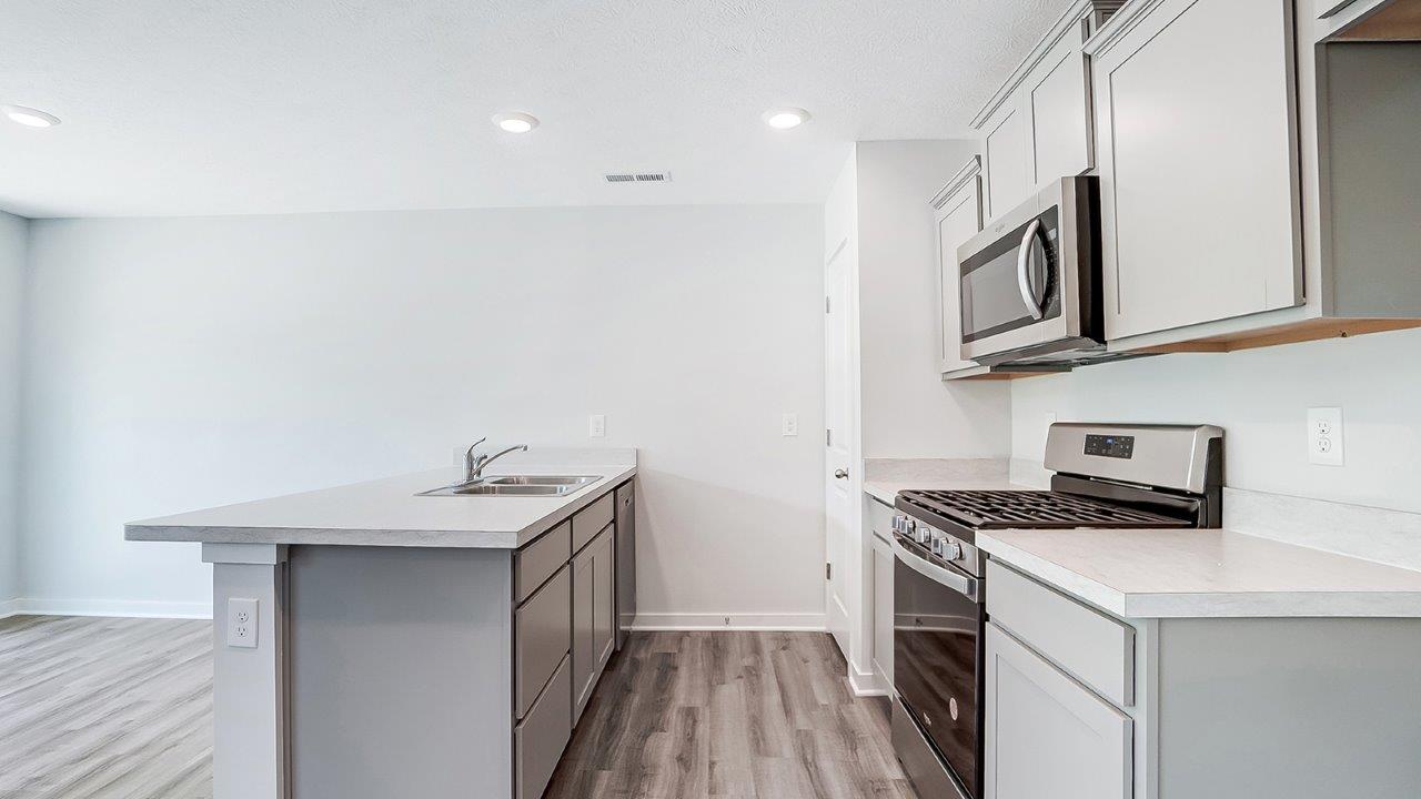 peninsula counter, grey cabinets, stainless steel appliances