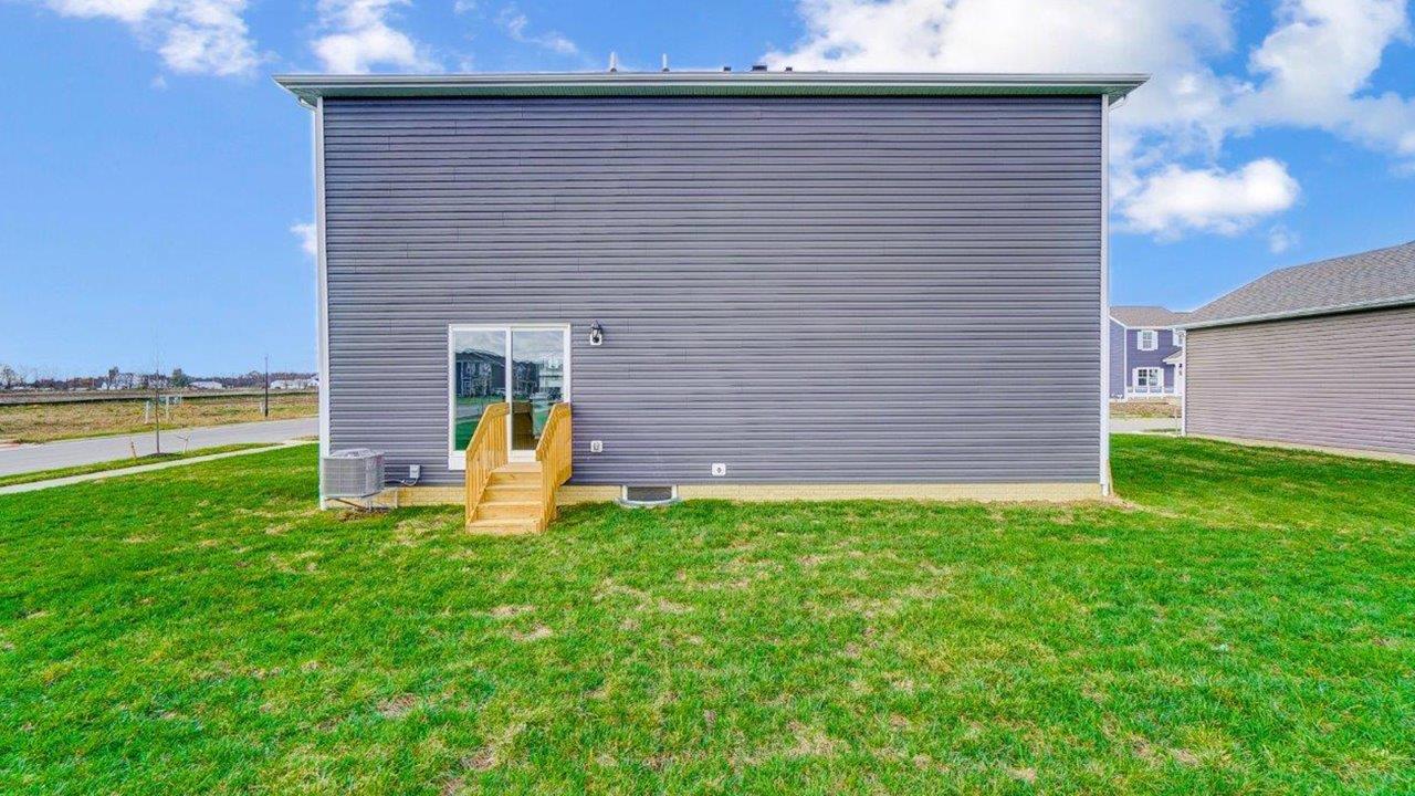 two story home with grey siding rear exterior