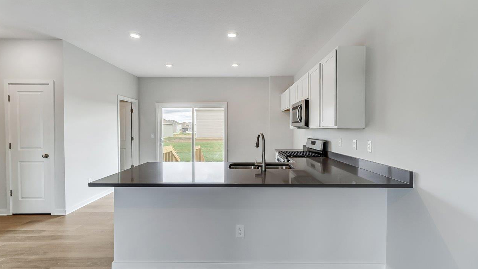 kitchen with peninsula counter, white cabinets
