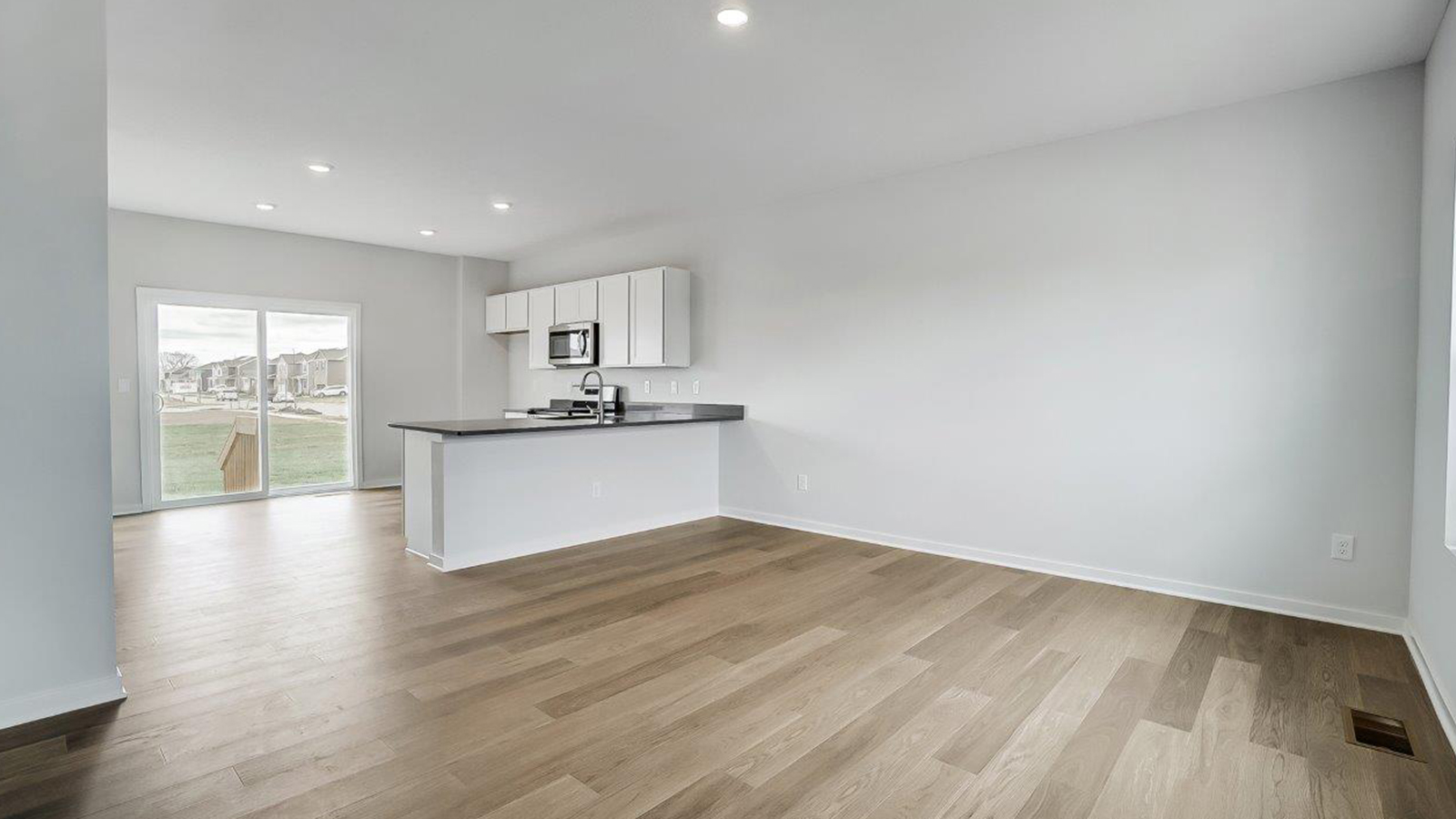 great room and kitchen with rear sliding door