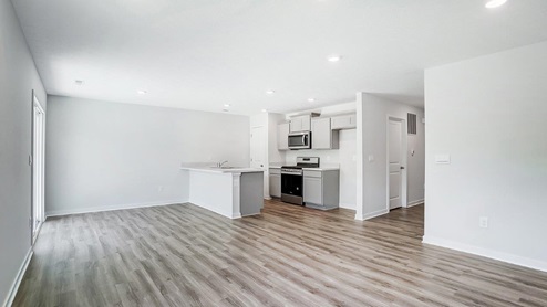Interior living area open to kitchen with light grey cabinets