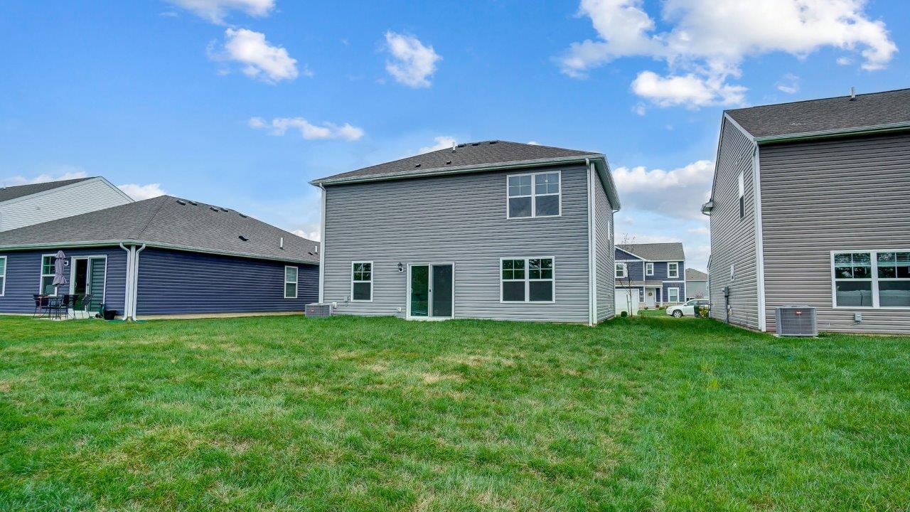 two story home with grey siding rear exterior