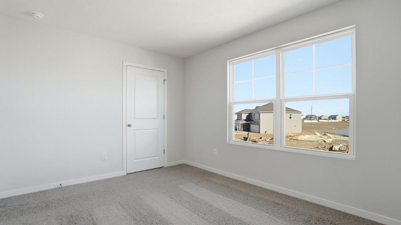 second bedroom with closet and double window