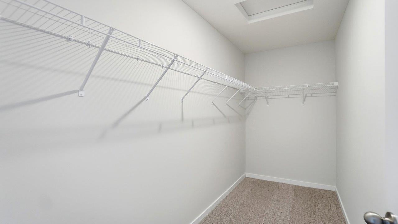 primary walk in closet with wire shelving