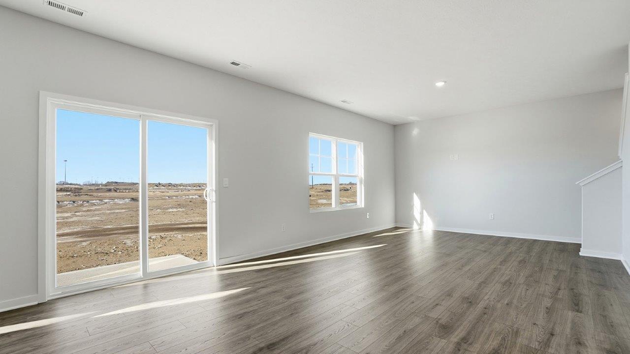 great room with rear sliding door and double window