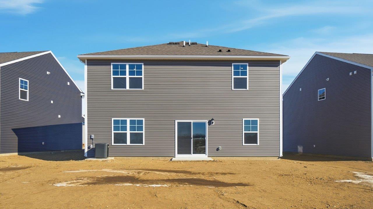 rear exterior of two story home with grey siding