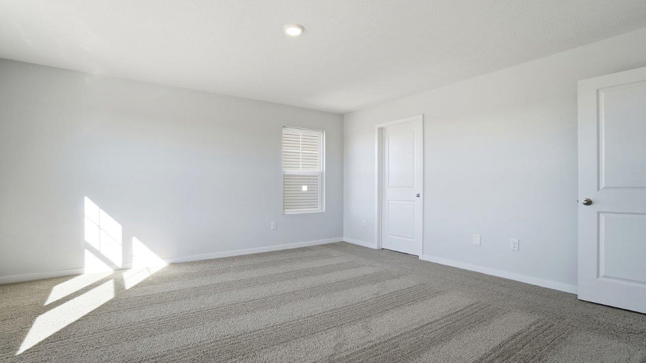 primary bedroom with single window and closet