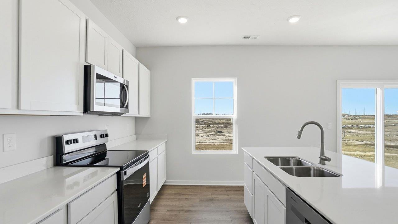 kitchen with white cabinets, stainless steel appliances, hard surface counters, single window