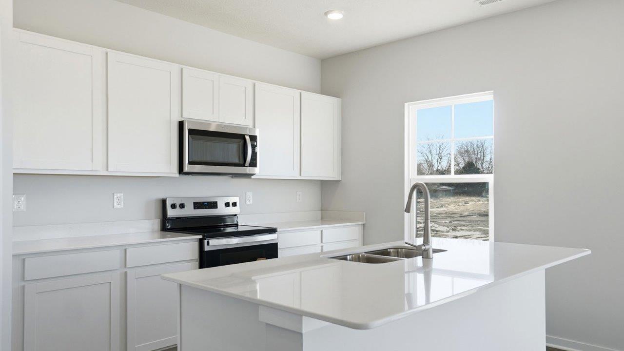 kitchen with white cabinets, stainless steel appliances, hard surface counters, single window