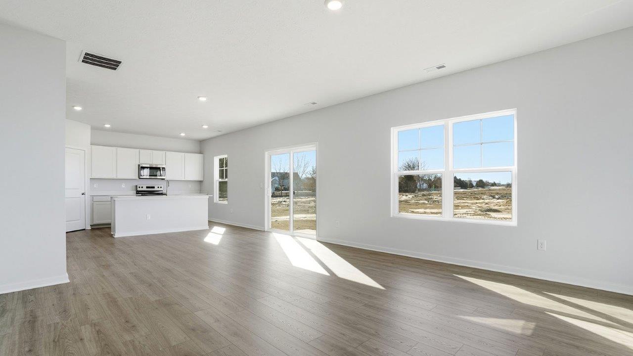 great room with rear sliding door, double window and kitchen