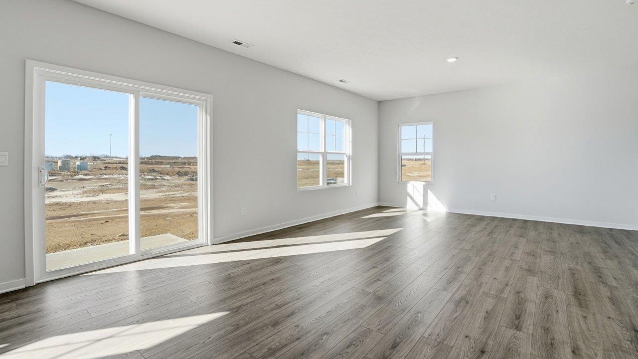 great room with rear sliding door and windows