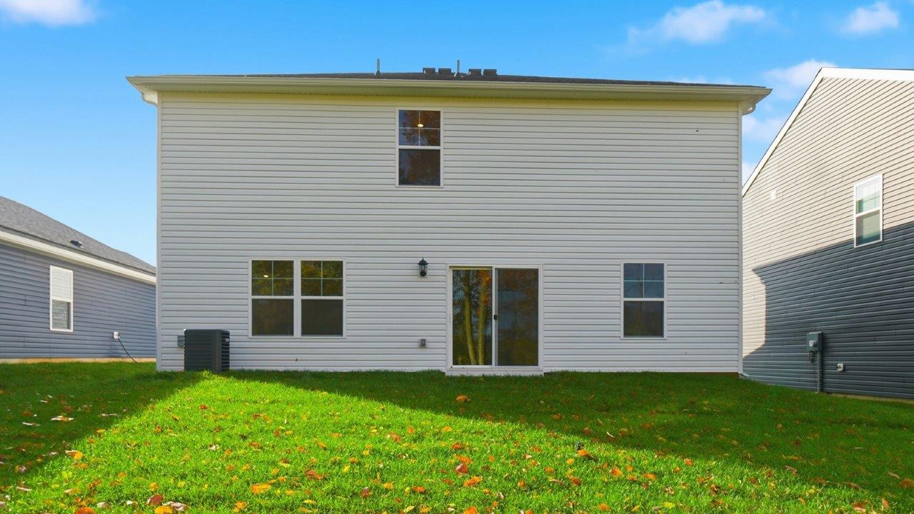 two story home with white siding rear exterior