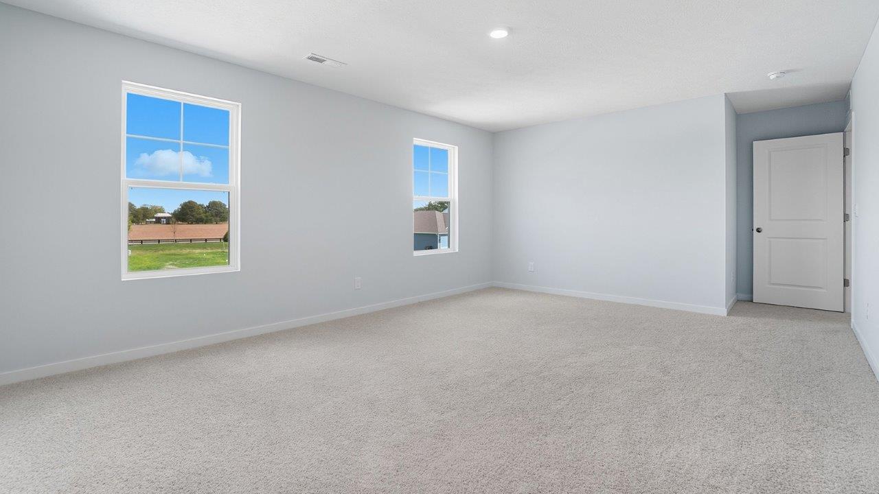 primary bedroom with single windows and entry