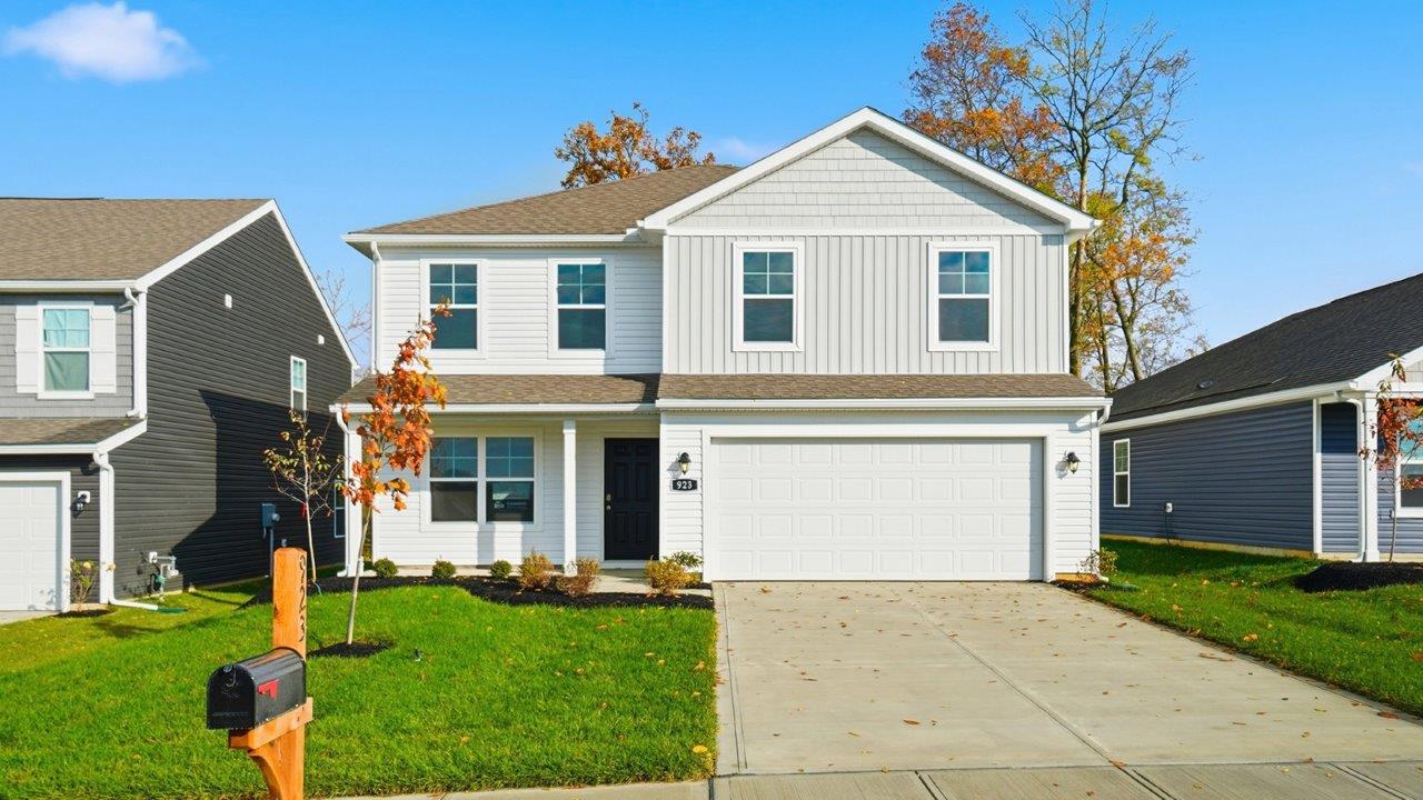 two story home with white siding, covered front porch and two car garage