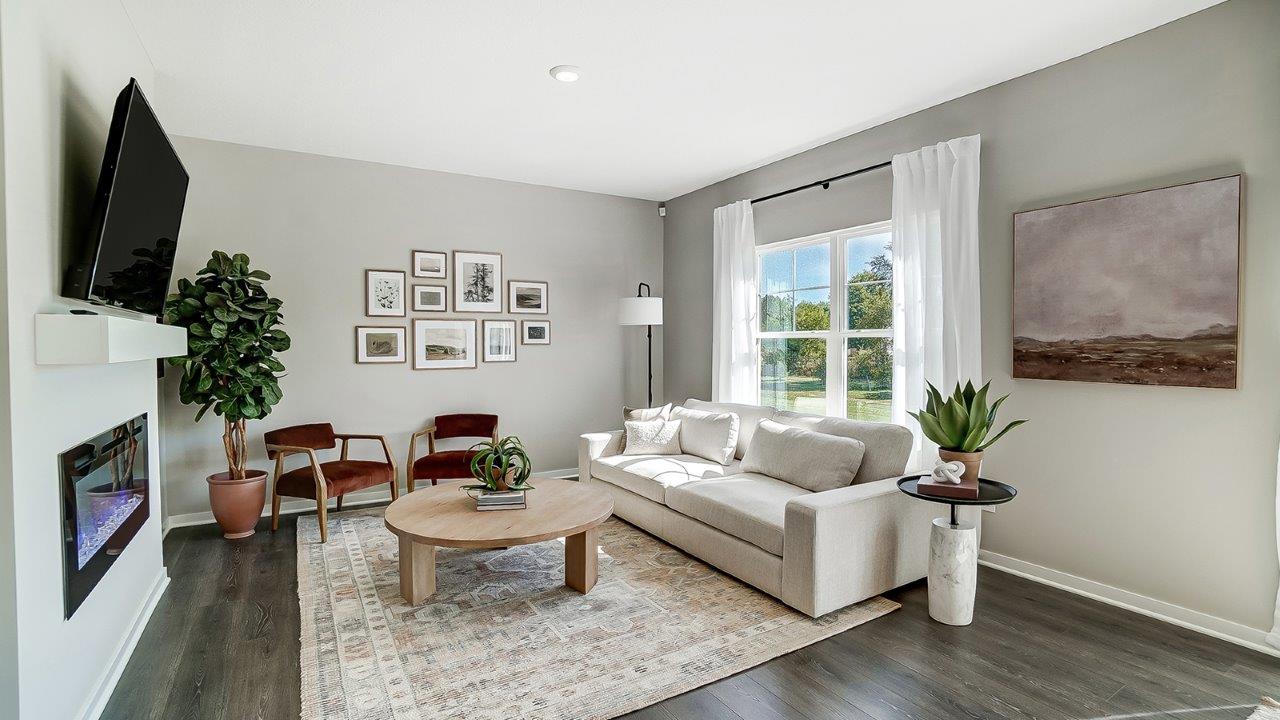 furnished great room with electric fireplace and double window