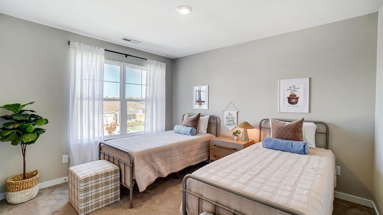 second bedroom with twin beds and double window