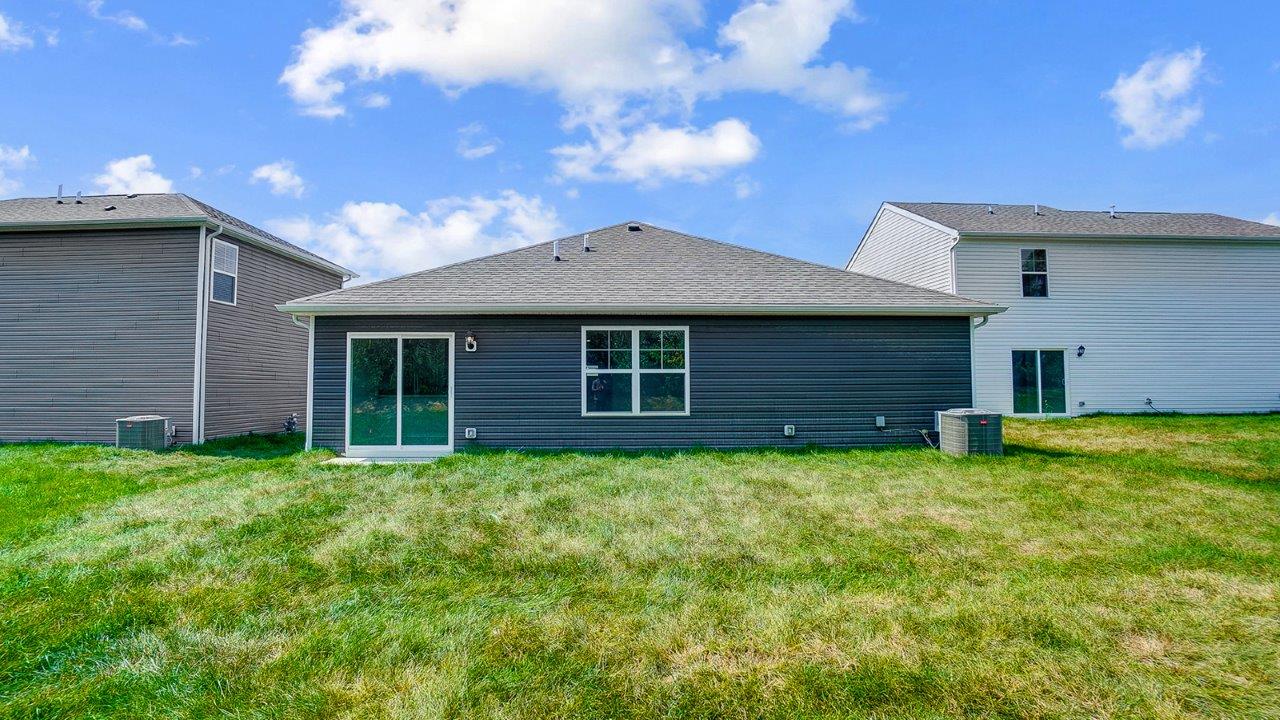 single story home with grey siding rear exterior