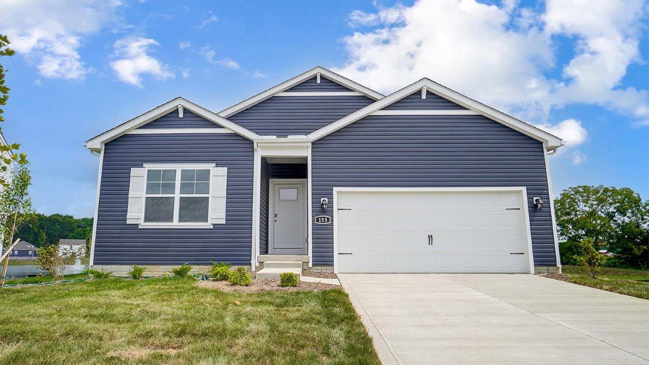 single story home with blue siding, covered entry and two car garage