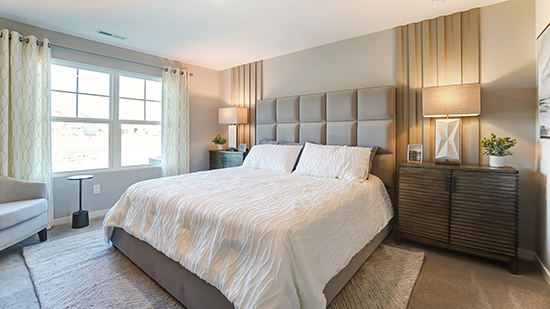 furnished primary bedroom with double window