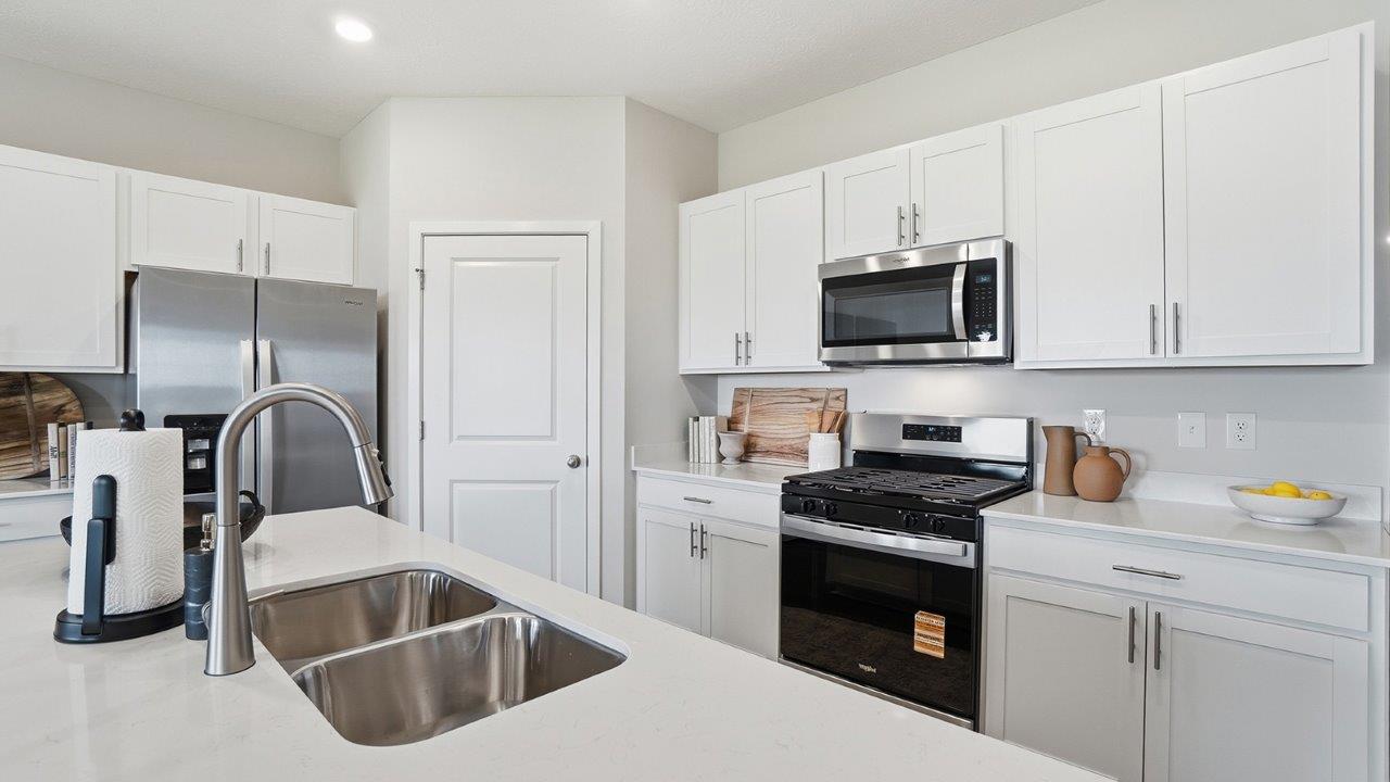 kitchen with white cabinets, corner pantry, built in island and corner pantry