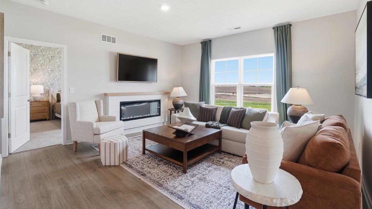 furnished great room with double window and electric fireplace