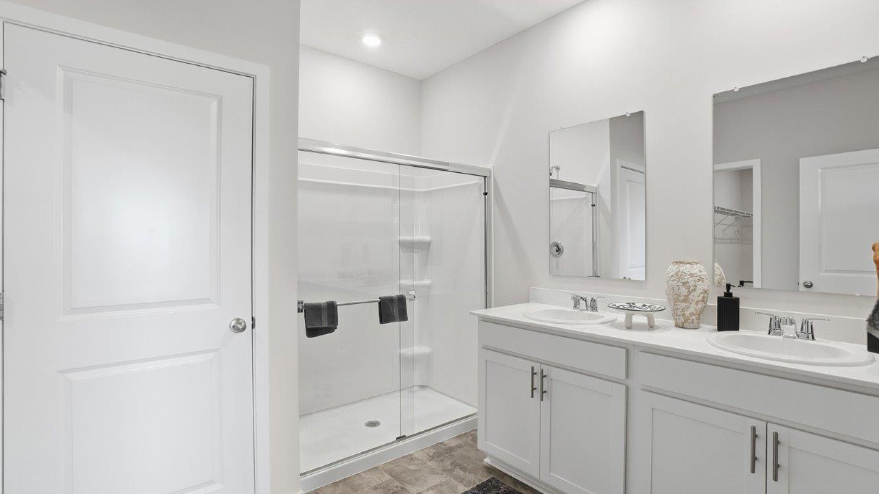 primary ensuite with double vanity and walk in shower