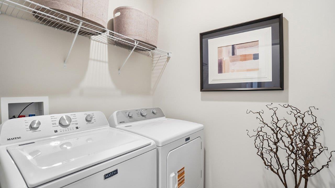 laundry room with washer and dryer, ventilated shelving