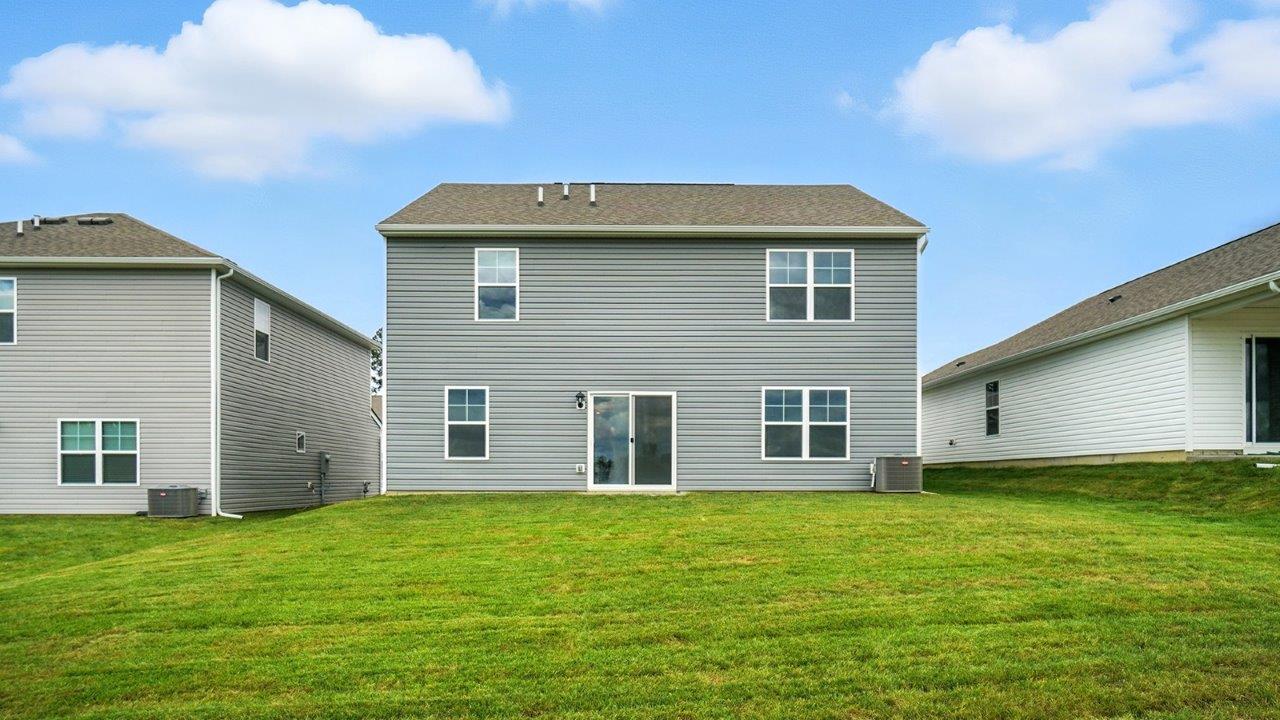 two story home with grey siding rear exterior