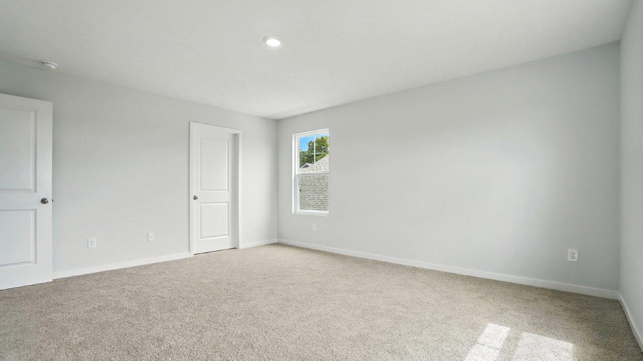 primary bedroom with single window, closet and entry