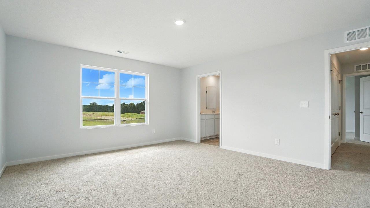 primary bedroom with double window, entry an ensuite bath
