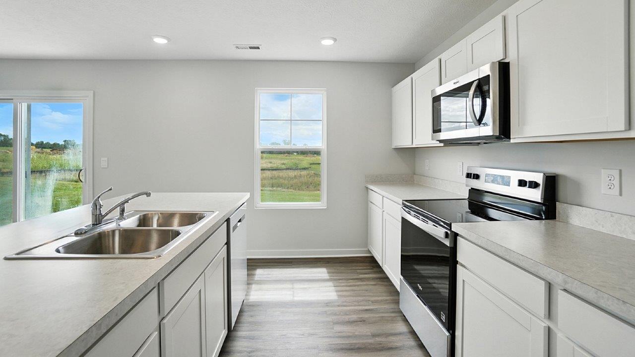 kitchen with white cabinets, stainless steel appliances and single window