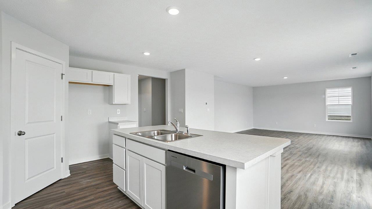 kitchen with walk in pantry, built in island and great room