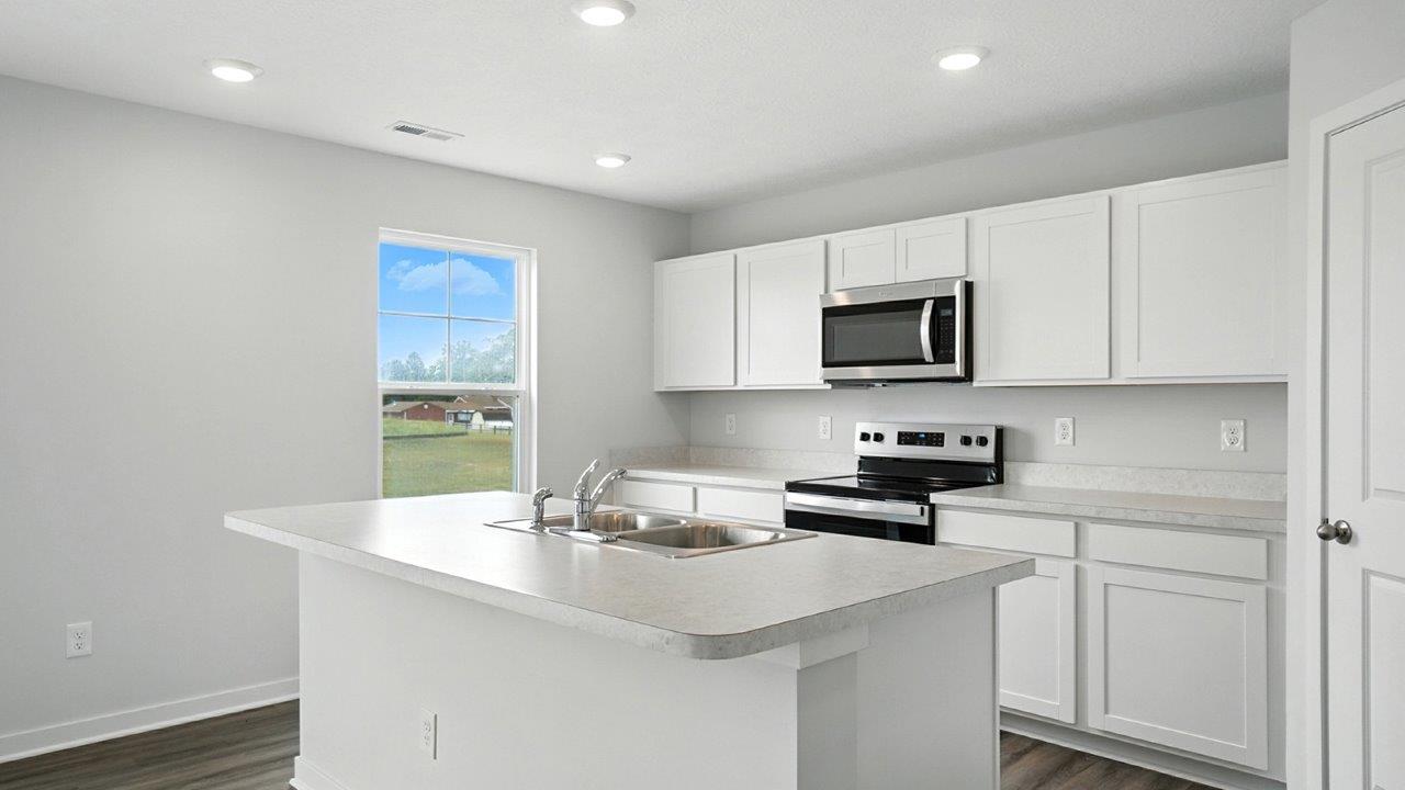 kitchen with white cabinets, stainless steel appliances and single window