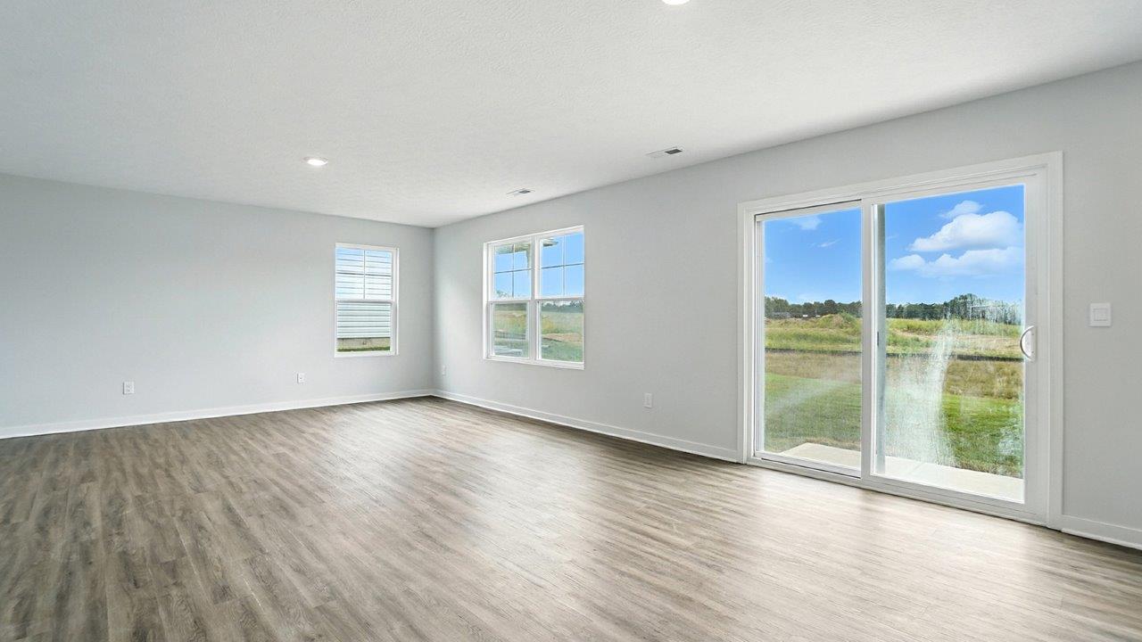 great room with two windows and rear sliding door