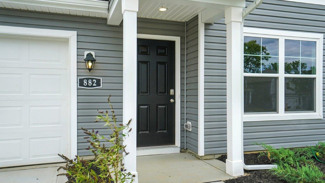 covered entry with black front door
