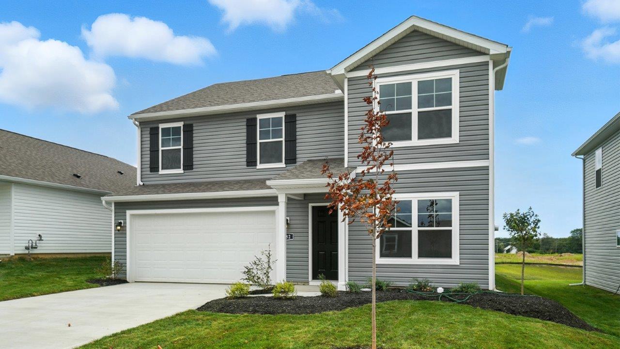 two story home with grey siding, covered entry and two car garage