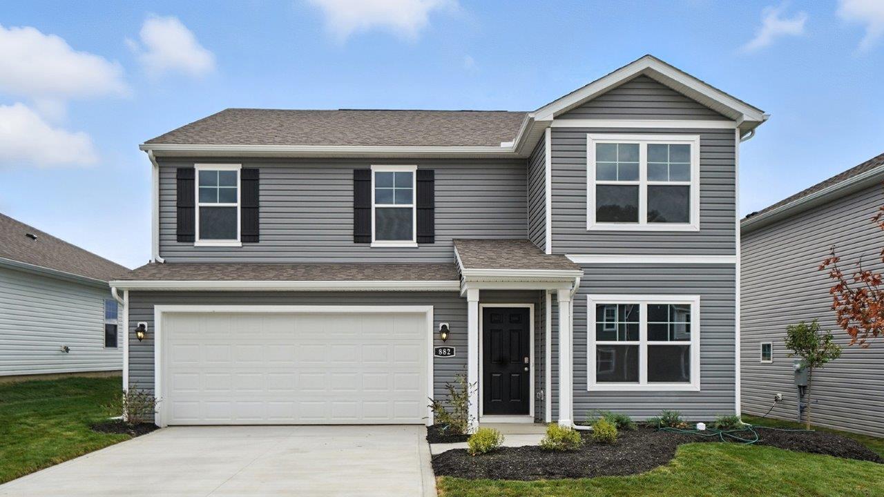 two story home with grey siding, covered entry and two car garage