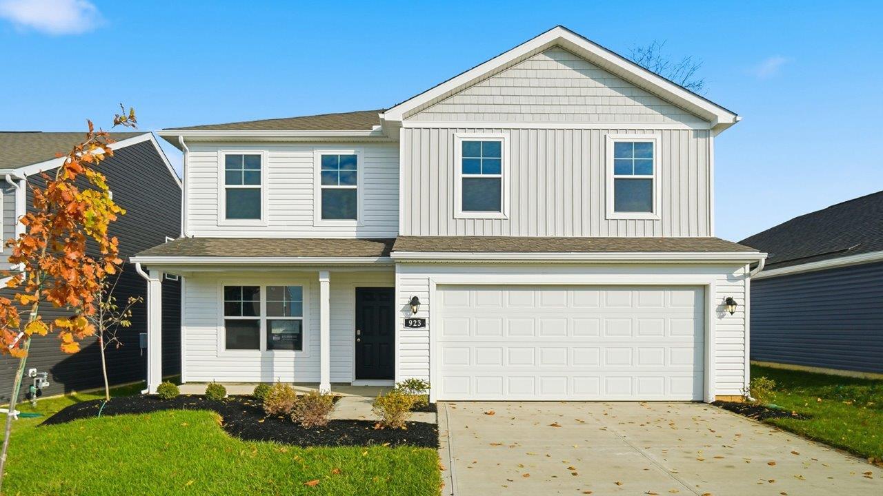 two story home with white and grey siding, covered front porch and two car garage