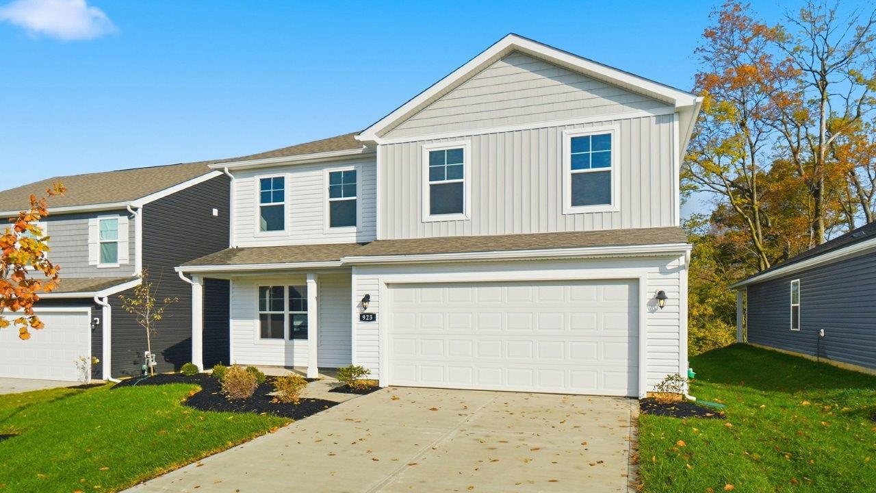 two story home with white and grey siding, covered front porch and two car garage