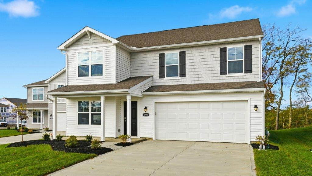 two story home with white siding, covered front porch and two car garage
