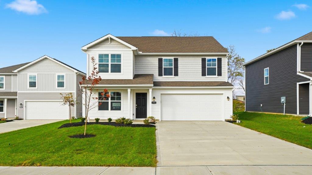 two story home with white siding, covered front porch and two car garage