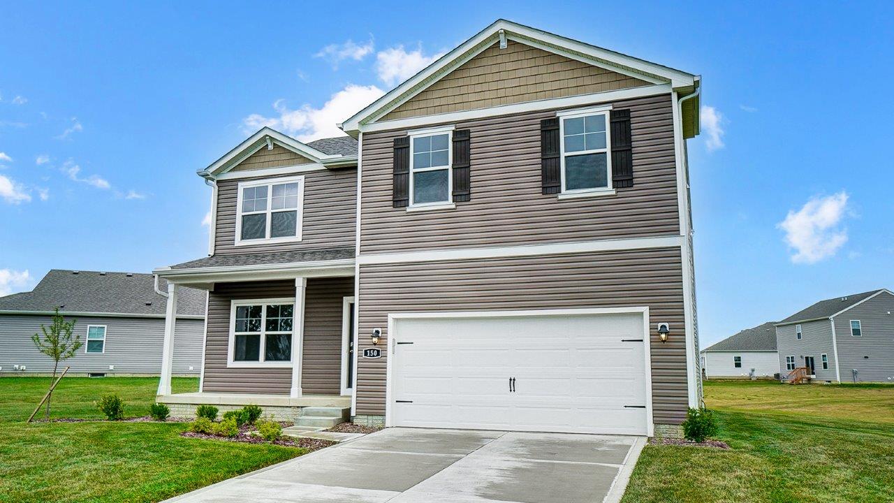two story home with brown siding, covered front porch and two car garage