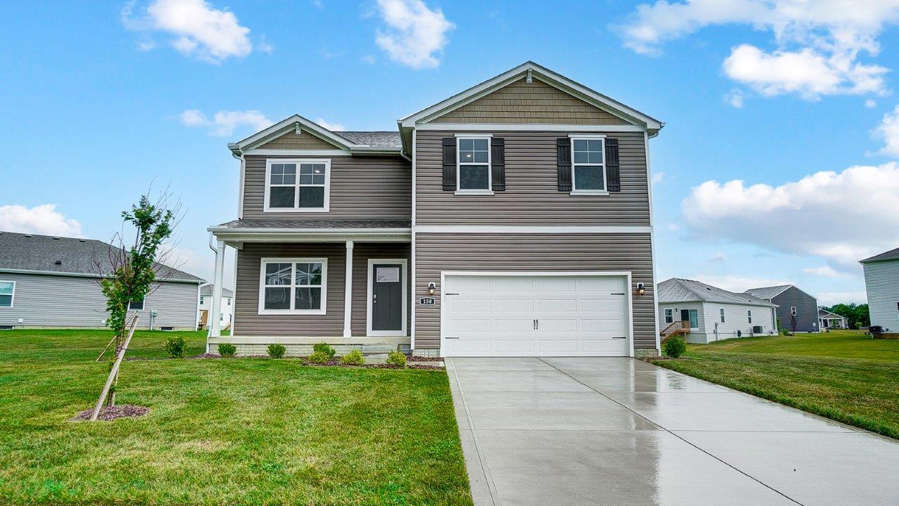 two story home with brown siding, covered front porch and two car garage